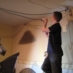 Col runs power cables for a ceiling-rigged light