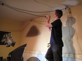 Col runs power cables for a ceiling-rigged light