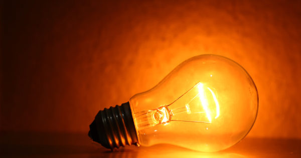 Tungsten bulbs emit an orange light - dim them down and it gets even more orangey.