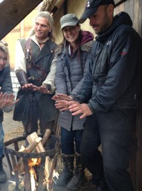 Actor Duran Fulton Brown, director Kate Madison and gaffer Richard Roberts warm their hands over a prop braziere.