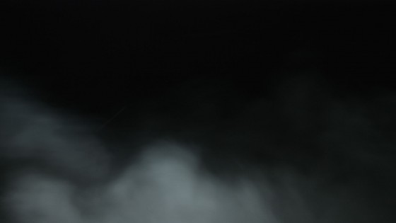 A smoke element shot against a black drape and backlit so that the smoke is visible but the drape is not